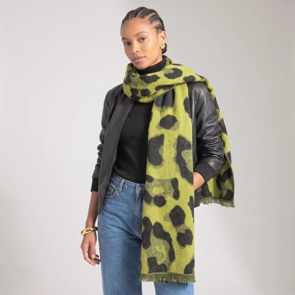Lime leopard print heavyweight scarf styled with black jacket and denim